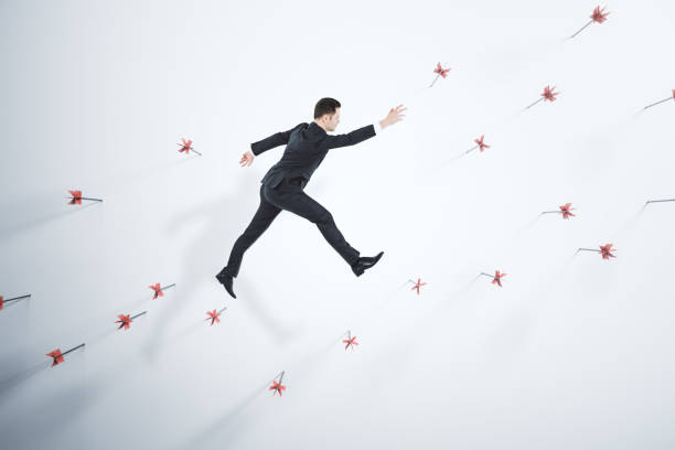 istock Businessman walking on abstract wall with many dart arrows. Goal setting and strategy concept. 1408596423