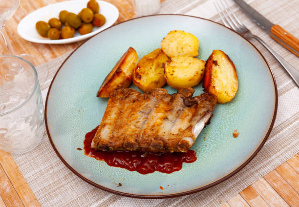 istock Baked under sauce pork ribs at plate with potatoes 1408596586
