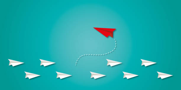 istock Red paper plane change direction from group on green background as metaphor for business creativity new idea. 1408598803
