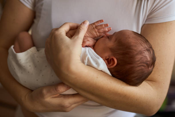 istock Mother holding her newborn baby in hands. 1408599652