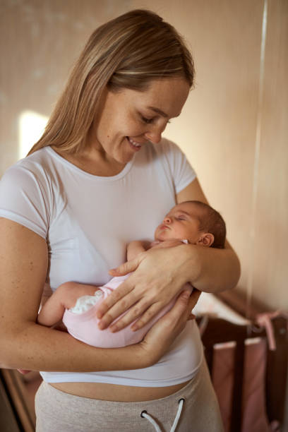 istock Mother holding her newborn baby in hands. 1408600007