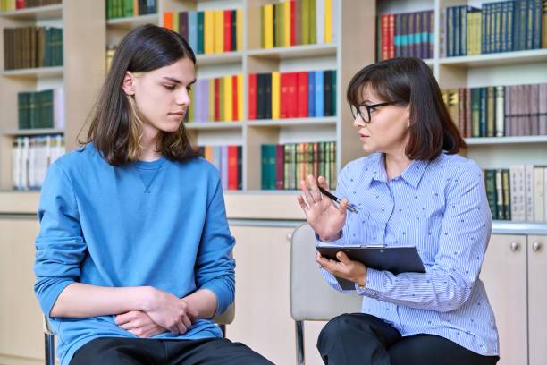 istock Individual therapy, social worker psychologist working with college student guy in library office 1408600056