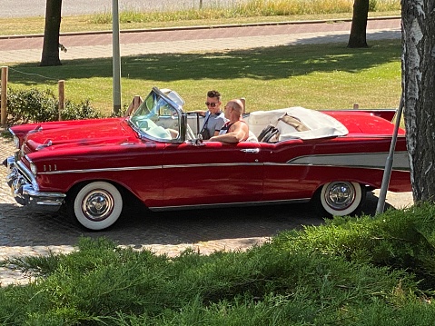 Brunssum, Netherlands - June 28, 2020.  Classic American convertible leaving for a trip on a summer day.
