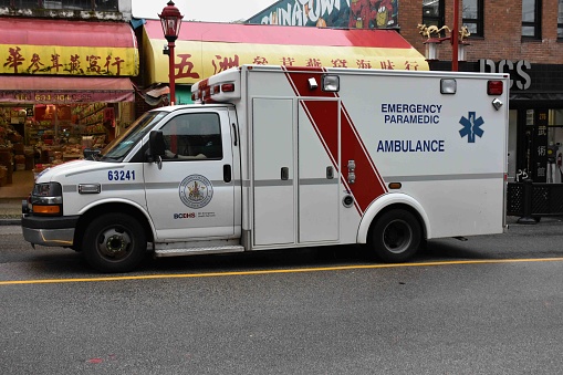 Vancouver City Ambulance Land Vehicle, Building Exterior Scene During Autumn Season In British Columbia Canada North America