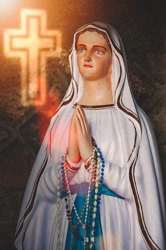 portrait of statue of virgin Mary with a glowing cross