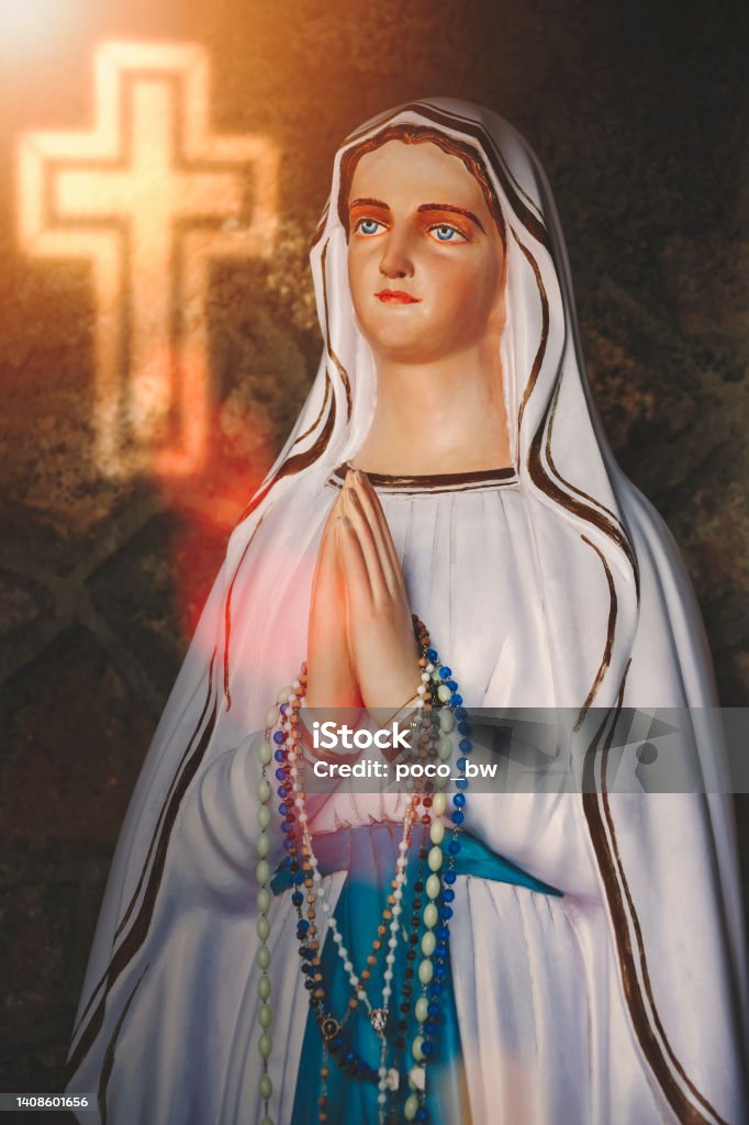 virgin Mary statue portrait of statue of virgin Mary with a glowing cross Aparecida Stock Photo