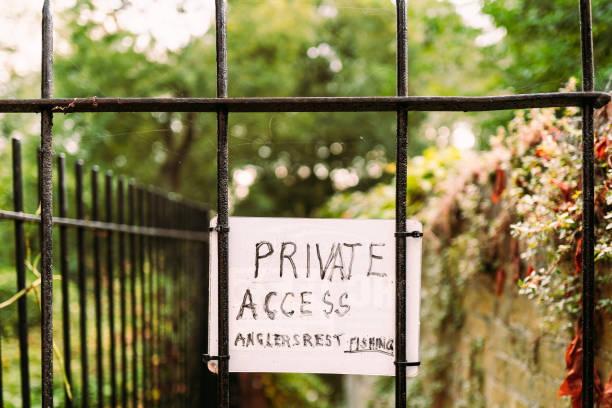 Ad hoc Private Access Sign seen attached to a wrought iron gate for access to a private fishing club.