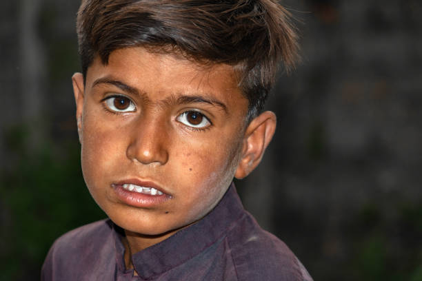 istock homeless and hungry boy staring at sad face expressions 1408604758
