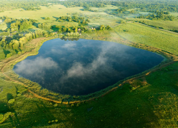 istock Lake in a morning mist at sunrise. 1408604915