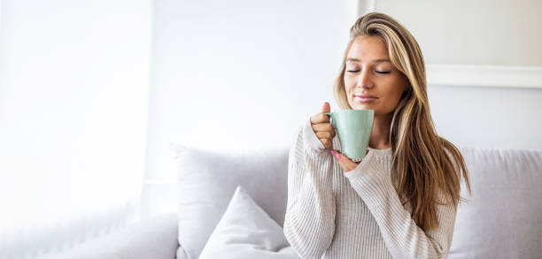 istock Side view of Happy brunette woman drinking coffee. 1408605320