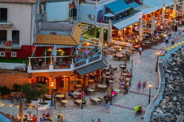 View of a restaurant patio. Romantic restaurant interior in Greece, wooden tables, chairs, stone stairs.