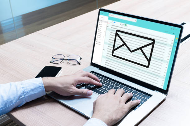istock Businessman hand on keyboard laptop with icon E-mail on display 1408610549