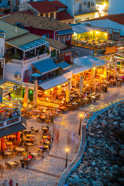 Panoramic night view of Parga city in Greece Amazing cityscape view of Parga city, Greece during the Summer. Beautiful architectural colorful buildings illuminated at night near the port of Parga Epirus, Greece parga greece stock pictures, royalty-free photos & images