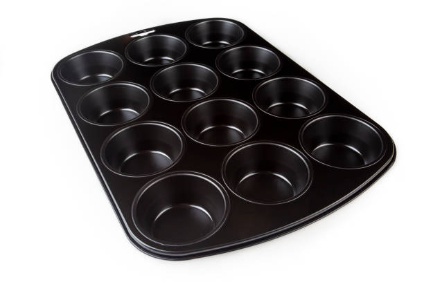 muffin cake pan with non-stick coating isolated on a white background. 12-cup muffin baking tray. empty cupcake bake ware for pie, tart, cake and pastries concepts. kitchen utensils. top view. - tart dessert tray bakery imagens e fotografias de stock