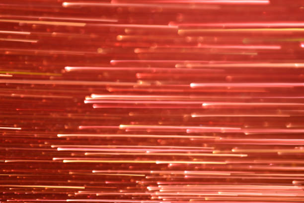 Light strip glistening sparkling bokeh on a glowing red background.