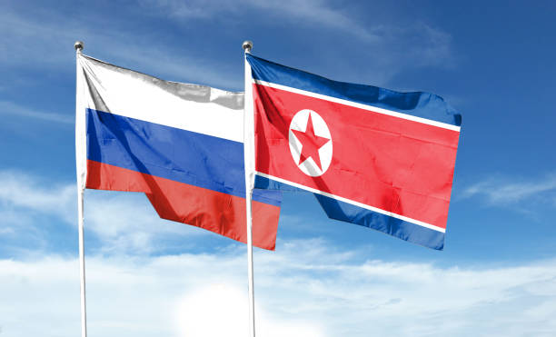 istock Twin Flags North Korea and Russia Waving Flags with Textured Background 1408612797