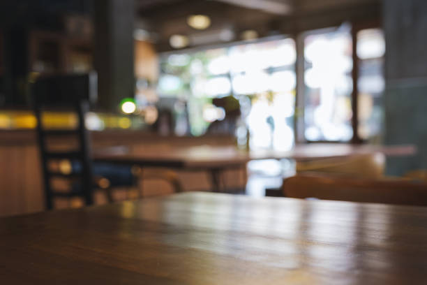 istock Wooden table top with blurred background in cafe 1408614390