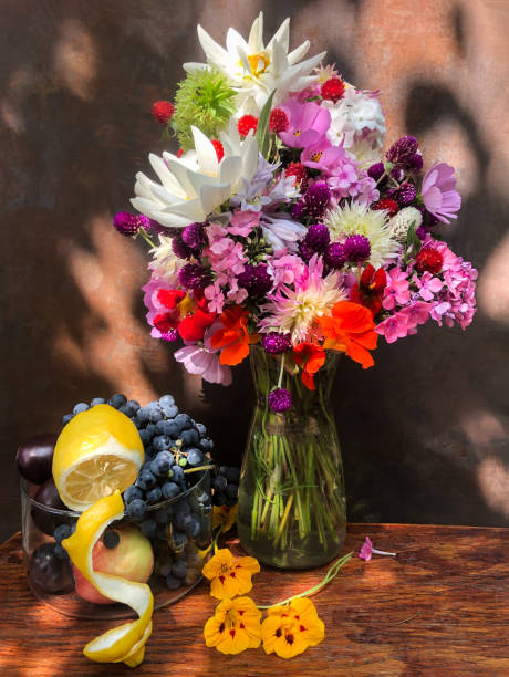 istock Bouquet with dahlias, phlox, nasturtium, gomphrena, eucomis, grapes and lemon 1408617854