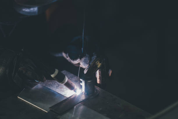 istock man Worker welding with electric arc electrode welding machine in factory 1408620782