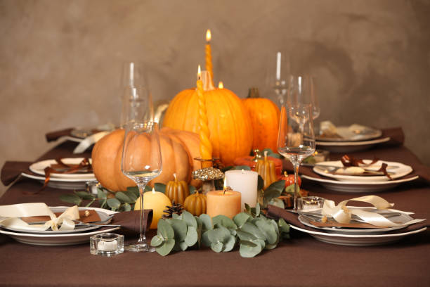 istock Beautiful autumn place setting and decor on table in room 1408622450