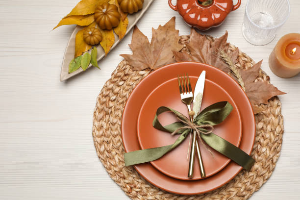 istock Beautiful place setting with autumn decor on white wooden table, flat lay 1408622828