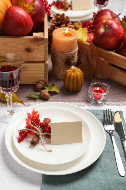 istock Beautiful autumn place setting with blank card and decor on table 1408622885