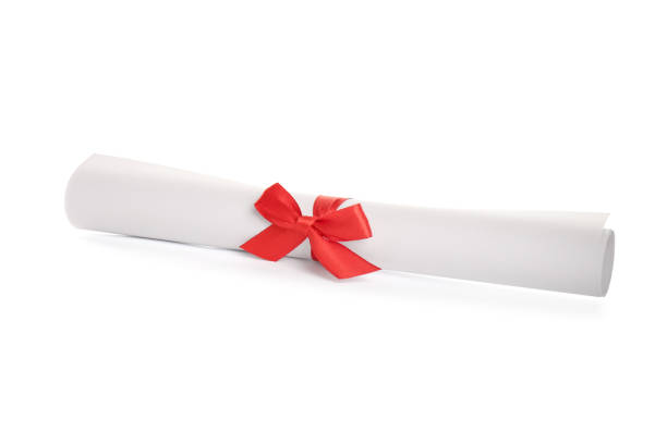 istock Rolled student's diploma with red ribbon isolated on white 1408623701