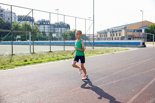 Boy running on outdoor track