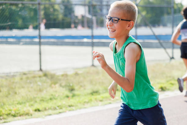 Smiling boy running on outdoor track