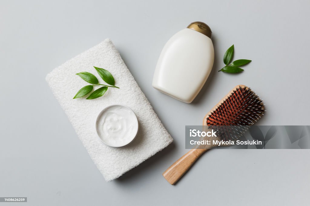 cosmetic for hair care, cream and towel on a colored background top view. flat lay cosmetic for hair care, cream and towel on a colored background top view. flat lay. Bathroom Stock Photo