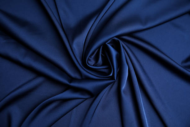 istock Crumpled dark blue silk fabric as background, top view 1408626477