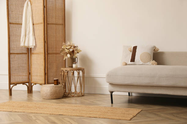 istock Stylish living room with folding screen and sofa. Interior design 1408626602