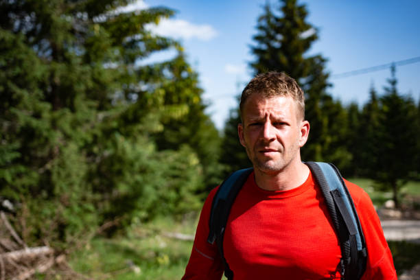 istock Young man hiking in the forest 1408626645
