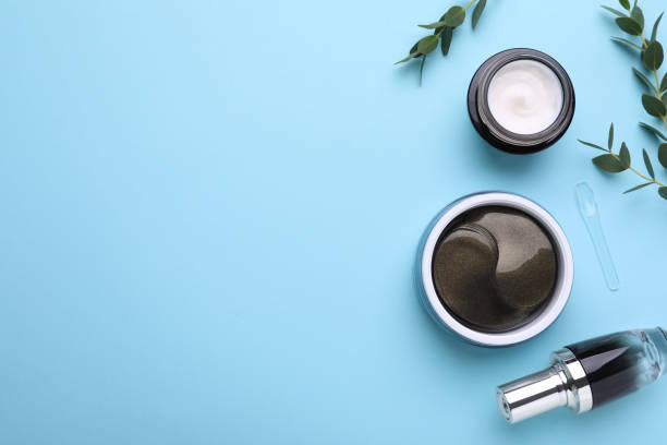 istock Flat lay composition with under eye patches and other cosmetic products on light blue background. Space for text 1408626956