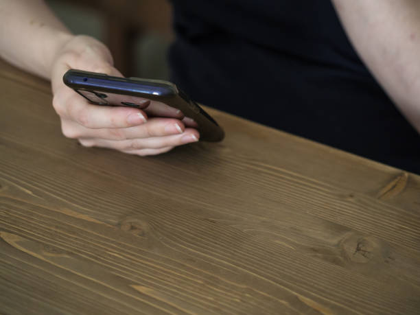istock Unrecognizable caucasian woman with smartphone in hand with copy space 1408627031