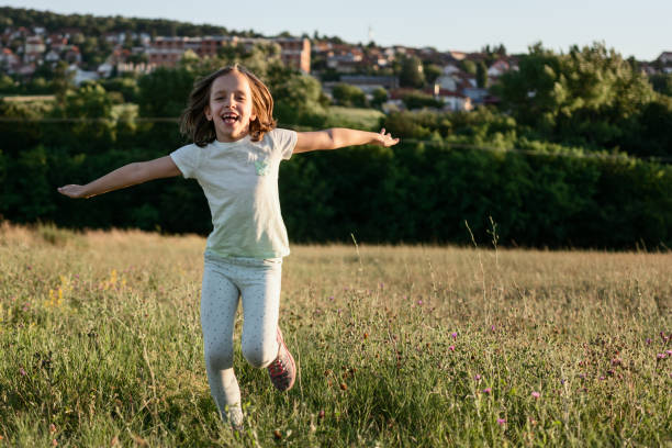 istock Girl running at the meadow 1408627071