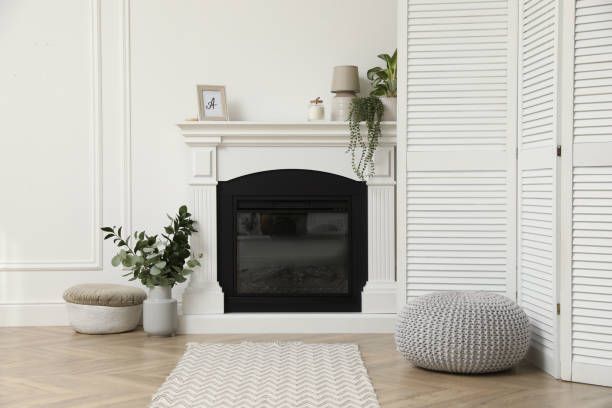 istock Stylish room with folding screen and fireplace. Interior design 1408627088