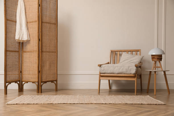istock Stylish room with folding screen and armchair. Interior design 1408628729