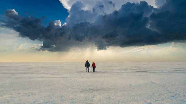 istock The two people walking through the endless snow field 1408629874