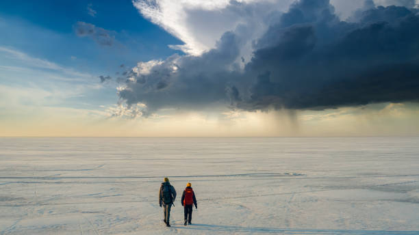 istock The two people walking through the endless snow field 1408629876