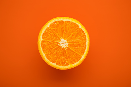 Cut orange citrus - food background, space for text