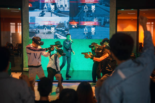 asian video game commentator host 2 asian esports teams playing vr shooting videogame competing each other in grand final on stage - esport audience bildbanksfoton och bilder
