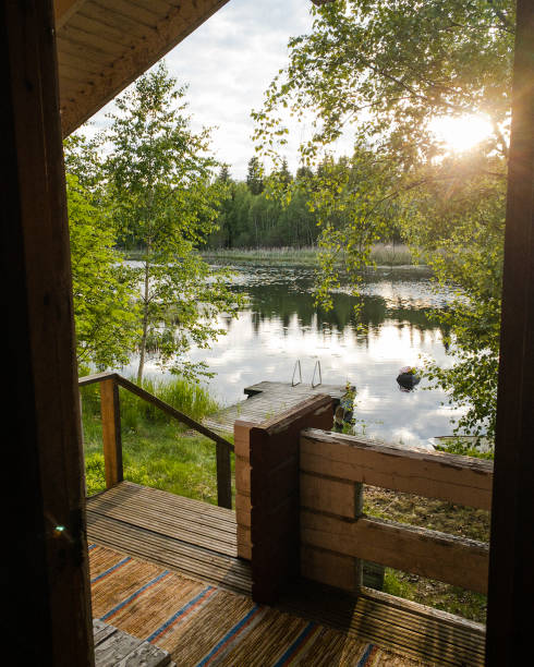 Finnish sauna by a lake with sunset in the view. Pictured from inside the sauna.