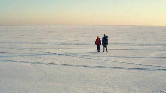 The two travelers walking through the arctic icy field