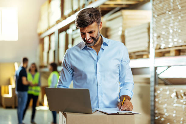 istock Warehouse Businessman with Laptop 1408640943