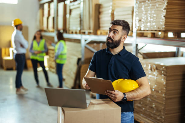 istock Warehouse inventory manager holding checklist and looking aside 1408641026