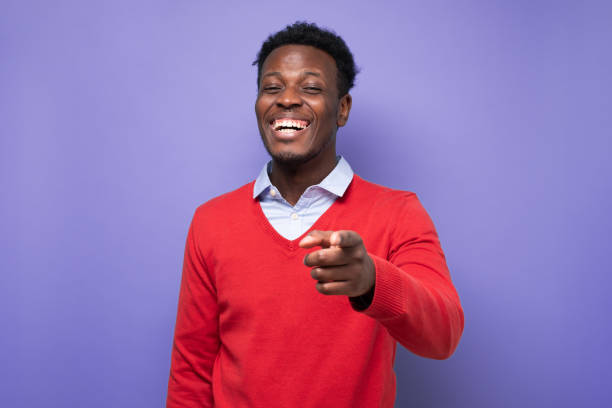 istock Laughing young african american man pointing index finger on camera 1408643139