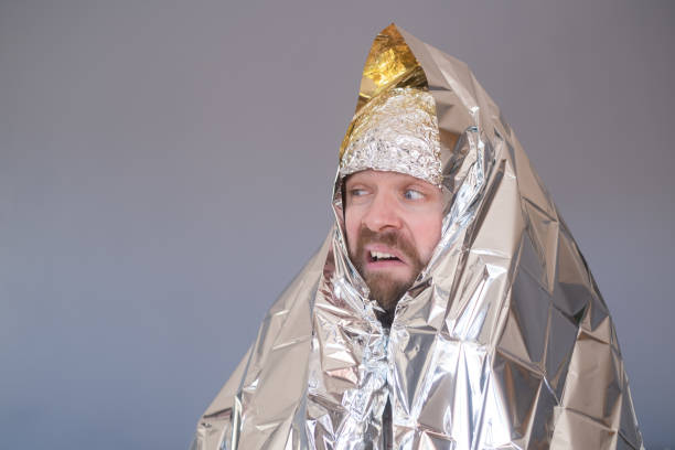 istock Lost hiker wrapped in an emergency survival blanket 1408643900