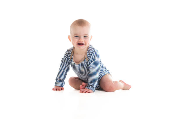 A Cheerful baby boy toddler on white studio background