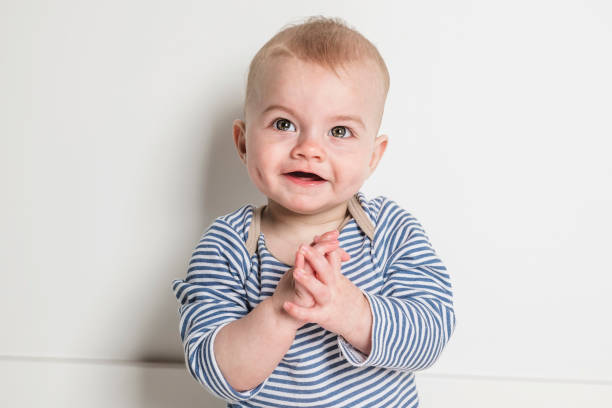 A Cheerful baby boy toddler on white studio background
